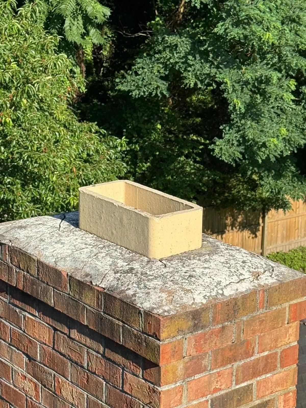 New flue tile extension on a brick chimney crown